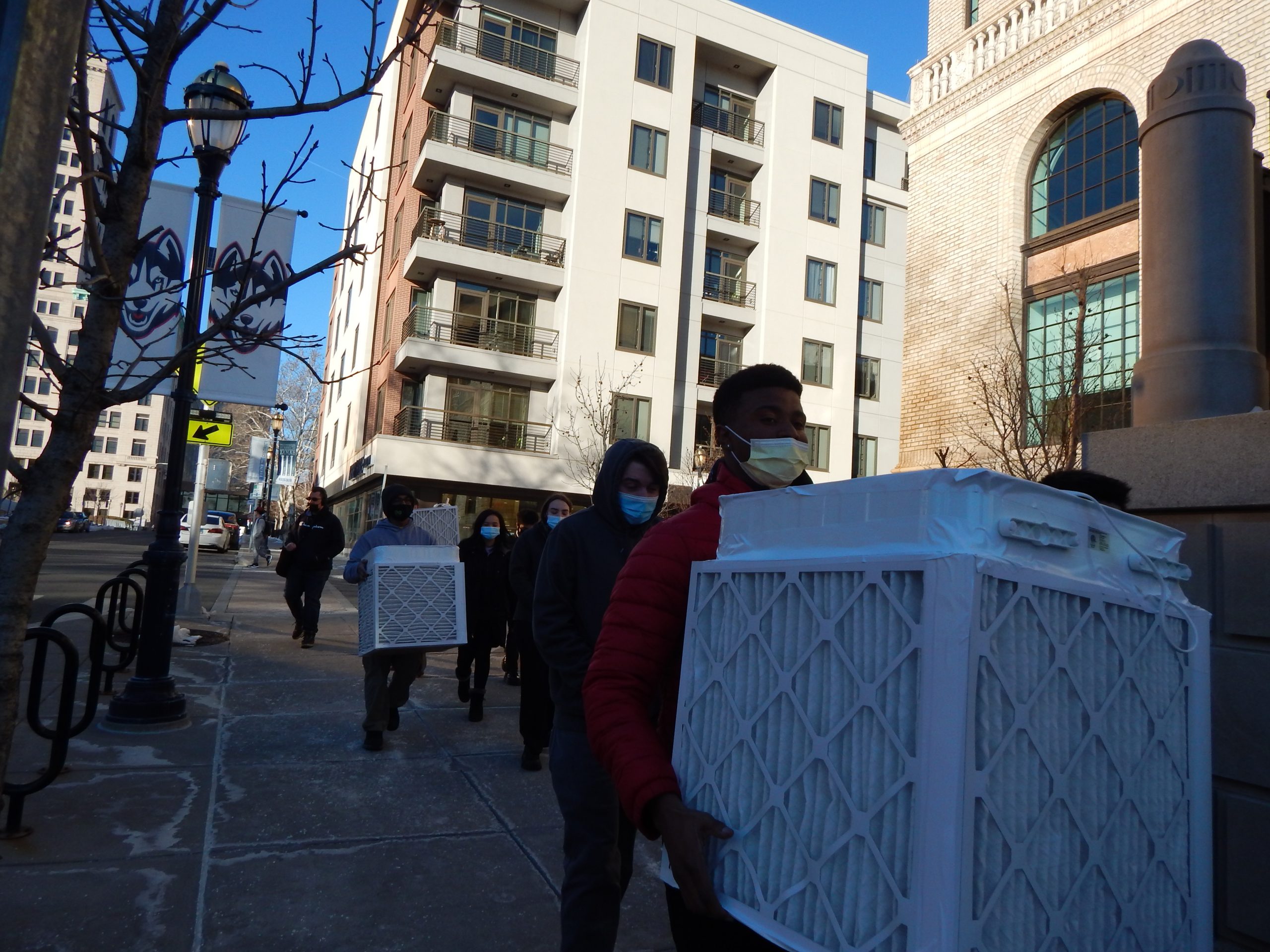 Students carrying the air filters from the UConn Hartford campus to the Hartford Public Library.